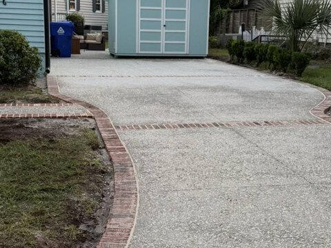 Exposed aggregate driveway with brick border
